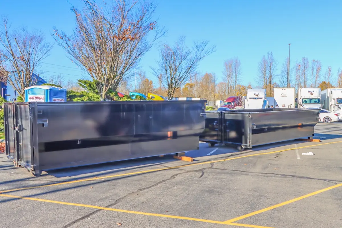 Professional dumpster rental service with roll-off container on residential driveway in Ave Maria